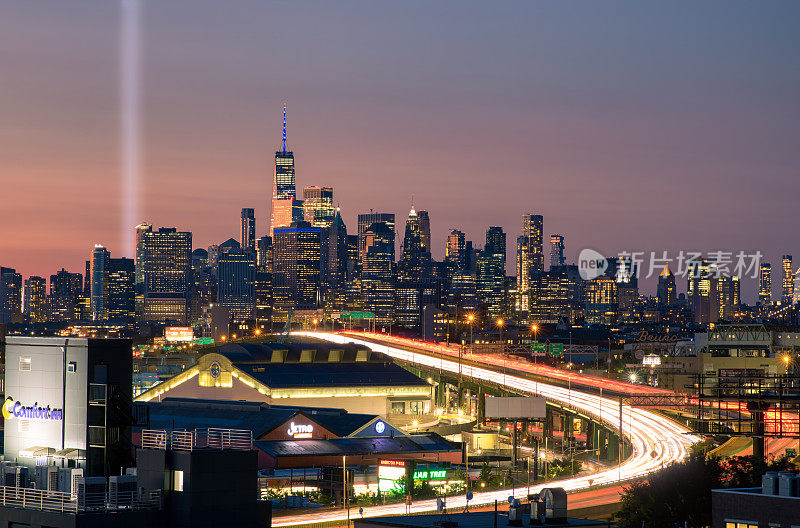日落时分，世贸大厦旁的9/11纪念灯。车灯从278号州际公路(I-278)驶往曼哈顿。